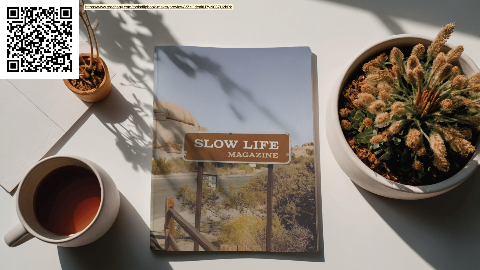 Flat-lay photo of a magazine titled “SLOW LIFE MAGAZINE” on a table, with a QR code in the corner, a cup of tea, and potted plants in soft daylight.